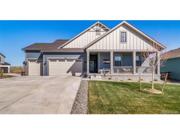 Charming home featuring a welcoming front porch and a well-maintained lawn at 1087 E Hopkins Dr, Elizabeth, CO 80107