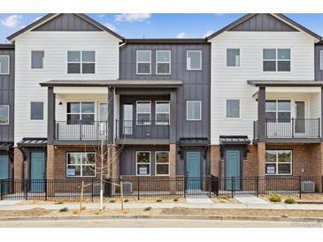 Attractive townhomes with modern design elements and inviting blue doors at 6804 Merseyside Ln, Castle Pines, CO 80108