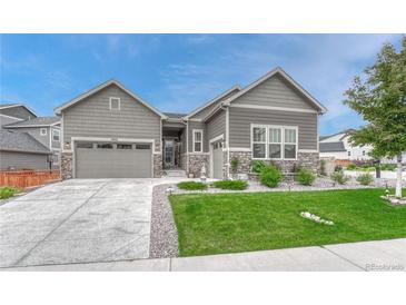 Charming single-Gathering home with a well-manicured lawn, stone accents, and a two-car garage at 2932 Eagle Wing Way, Castle Rock, CO 80109