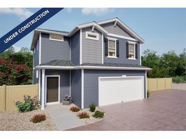 Charming two-story home featuring blue siding, a white garage door, and professionally landscaped front yard at 46505 Sunflower Ln, Bennett, CO 80102
