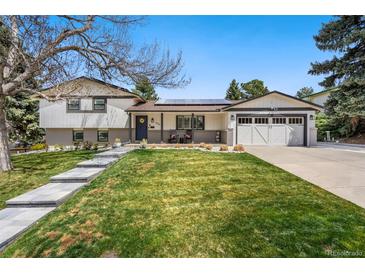 Charming two-story home with beautifully landscaped front yard and welcoming entrance at 6439 E Maplewood Ave, Centennial, CO 80111