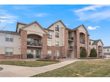 Attractive 2-story condo building with landscaping and walkway at 7292 S Blackhawk St # 2-103, Englewood, CO 80112