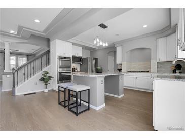 Modern kitchen featuring stainless steel appliances, a kitchen island with seating, and recessed lighting at 2354 Cactus Bloom Ct, Castle Rock, CO 80109