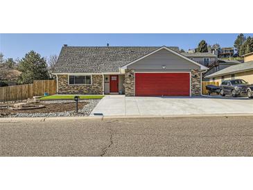 Charming single-Gathering home with brick accents, a red garage door, and a well-maintained front yard at 7814 W Ontario Pl, Littleton, CO 80128