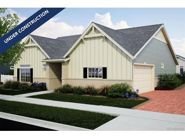 New construction home showcasing a two-car garage, board and batten siding, and a manicured lawn at 21947 E 51St Dr, Aurora, CO 80019