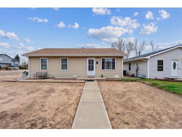 Charming single-story home with a well-maintained exterior and walkway at 1418 5Th St, Fort Lupton, CO 80621