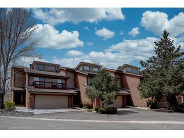 Beautiful townhouse with brick facade, two-car garage, balcony and mature trees at 3515 S Dawson St, Aurora, CO 80014