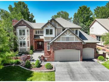 Inviting two-story home featuring a three-car garage and manicured front yard at 11904 W Auburn Dr, Denver, CO 80228