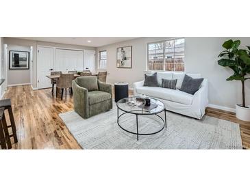 Inviting living room with a white sofa, and hardwood floors at 5235 Dover St, Arvada, CO 80002