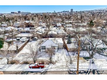 Aerial view of house and property in snowy neighborhood at 11842 W 14Th Ave, Lakewood, CO 80401