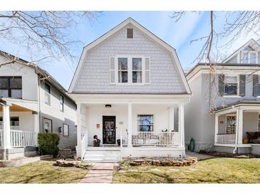 Charming two-story home with a welcoming front porch, manicured lawn, and mature trees at 432 N Ogden St, Denver, CO 80218
