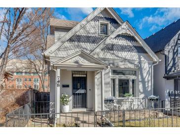 Charming home with detailed trim, a small front yard, and a cozy, welcoming entryway at 748 Elati St, Denver, CO 80204
