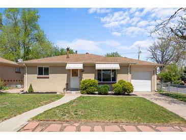 Charming one-story brick home with well-maintained lawn and awning-covered windows at 7736 Vallejo St, Denver, CO 80221