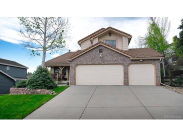 Charming two-story home featuring a three-car garage and a well-manicured front lawn at 76 Buckthorn Dr, Littleton, CO 80127