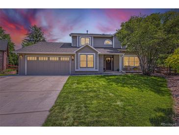 Charming two-story home featuring a well-manicured lawn, a two-car garage, and inviting curb appeal at 5 Cliffrose, Littleton, CO 80127