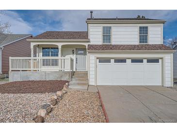 Charming two-story home with a front porch, garage and landscaped front yard at 2888 S Fundy St, Aurora, CO 80013