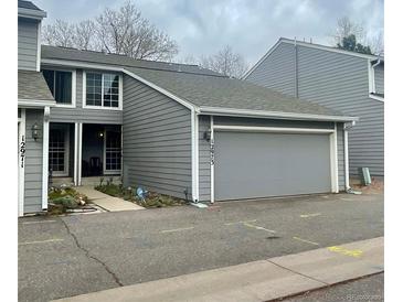 Charming two-story townhome with an attached two-car garage and well-maintained landscaping at 12973 E Cornell Ave, Aurora, CO 80014
