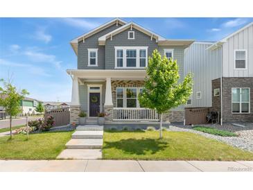 Charming two-story home with landscaped front yard and inviting porch at 20998 E 60Th Pl, Aurora, CO 80019