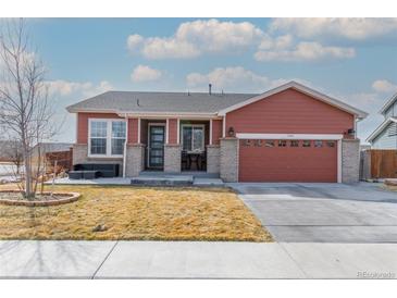 Charming single-Gathering home featuring a well-maintained lawn, covered porch, and a two-car garage at 13601 Krameria St, Thornton, CO 80602