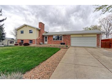 Charming two-story home features a well-maintained lawn and a classic brick exterior at 10538 Quivas St, Northglenn, CO 80234