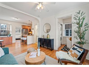 Open layout combines living spaces, showcasing the seamless integration of hardwood floors and natural light at 945 N Washington St # 201, Denver, CO 80203