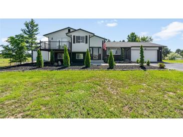 Charming two-story home featuring black and white accents, a deck, and well-manicured landscaping at 9232 N Surrey Dr, Castle Rock, CO 80108