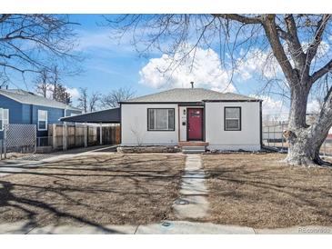 Charming single-story home featuring a red door, carport, and landscaped front yard at 4573 S Acoma St, Englewood, CO 80110