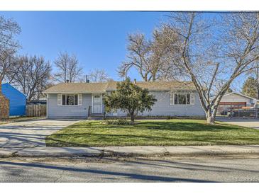 Ranch style home with a large yard and driveway at 4855 Dover St, Arvada, CO 80002