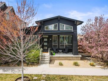 Charming single-Gathering home featuring a minimalist modern design and welcoming front porch in a landscaped yard at 2777 Ironton St, Denver, CO 80238