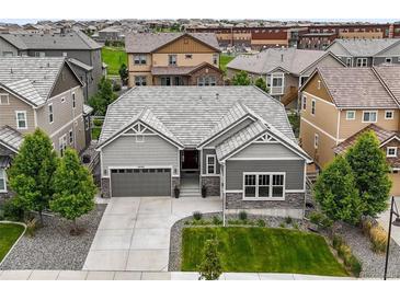 Charming single-Gathering home features neutral toned exterior, landscaped yard, and a convenient two-car attached garage at 16256 Ute Peak Way, Broomfield, CO 80023