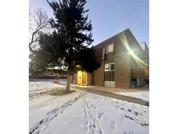 Attractive exterior of a two-story building with landscaping and snow at 7755 E Quincy Ave # 107, Denver, CO 80237