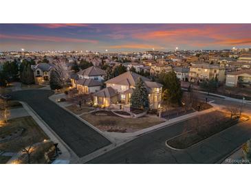 Stunning aerial view of a beautiful home in a well-developed neighborhood at dusk at 9368 S Silent Hills Dr, Lone Tree, CO 80124