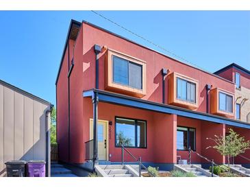 Modern townhome with a rust colored exterior and box style windows at 3943 W 12Th Ave, Denver, CO 80204