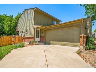 Two-story home featuring an attached two-car garage and mature landscaping at 12565 Eudora St, Thornton, CO 80241
