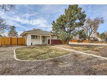 Charming single story home with a well manicured lawn and a large tree, fenced in yard at 1277 Wabash St, Denver, CO 80220