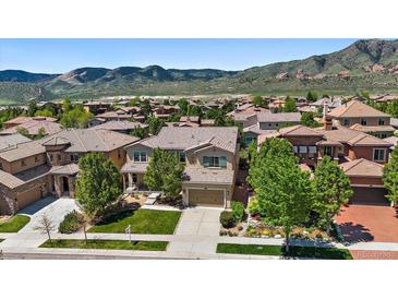 Charming two-story home with a well-manicured lawn and beautiful mountain views at 2263 S Loveland St, Lakewood, CO 80228
