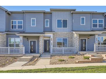 Beautiful townhome featuring stone accents, covered entry, and neat landscaping at 1965 S Haleyville Way, Aurora, CO 80018