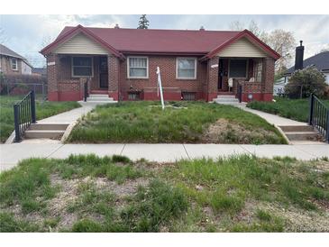 Charming brick duplex with red roof, inviting entrances, and walkways in need of some TLC at 3547 N Clayton St, Denver, CO 80205