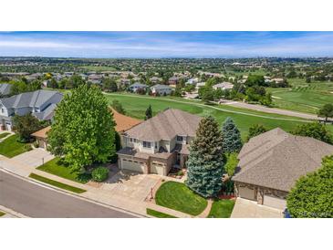 Stunning aerial view of home on golf course with lush landscaping and mature trees at 6323 S Sicily Way, Aurora, CO 80016