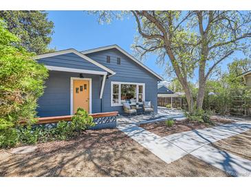 Charming single Gathering home with covered porch and beautiful walkway with mature landscaping at 2942 Chase St, Wheat Ridge, CO 80214