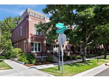 Charming brick townhomes near street sign with well-maintained landscaping and sidewalks at 2 S Monroe St, Denver, CO 80209