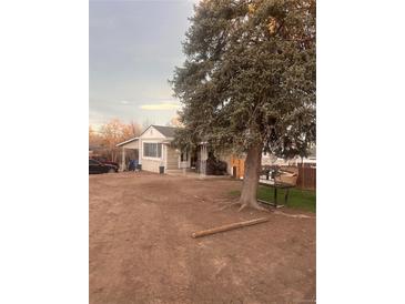 Ranch style home with large tree and spacious yard at 80 Xavier St, Denver, CO 80219