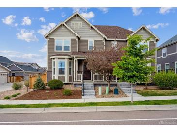 Charming two-story home featuring a well-maintained lawn, garden beds, and neutral-toned facade at 3831 E 141St Ave, Thornton, CO 80602