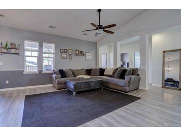 Comfortable living room with neutral tones, a ceiling fan and an oversized sectional at 6722 S Winnipeg Cir # 102, Aurora, CO 80016