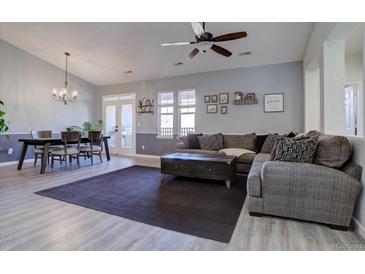 Bright, open living space with modern decor, ceiling fan, and dining area at 6722 S Winnipeg Cir # 102, Aurora, CO 80016