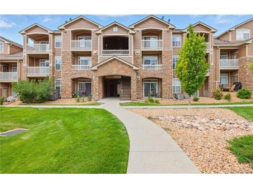 A beautiful condo with stone accents, multiple balconies, and a well maintained green space creates curb appeal at 7440 S Blackhawk St # 2-203, Englewood, CO 80112