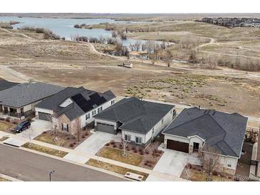 A high angle view shows an upscale neighborhood and peaceful lake, perfect for a relaxing lifestyle at 26741 E Peakview Pl, Aurora, CO 80016