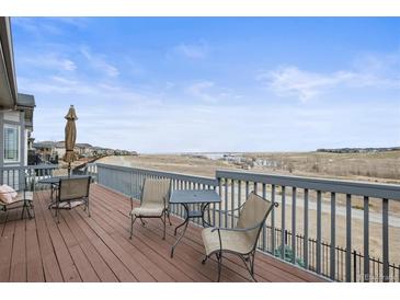Enjoy the views from this back deck complete with table, chairs, and an umbrella at 26741 E Peakview Pl, Aurora, CO 80016