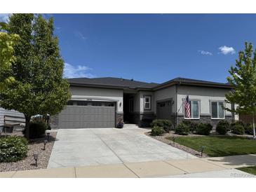 Charming ranch style home featuring a two-car garage, landscaped yard, and an inviting entrance at 26741 E Peakview Pl, Aurora, CO 80016