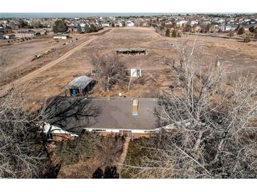 Aerial view of a home featuring a traditional roof and mature trees at 18199 E 160Th Ave, Brighton, CO 80601